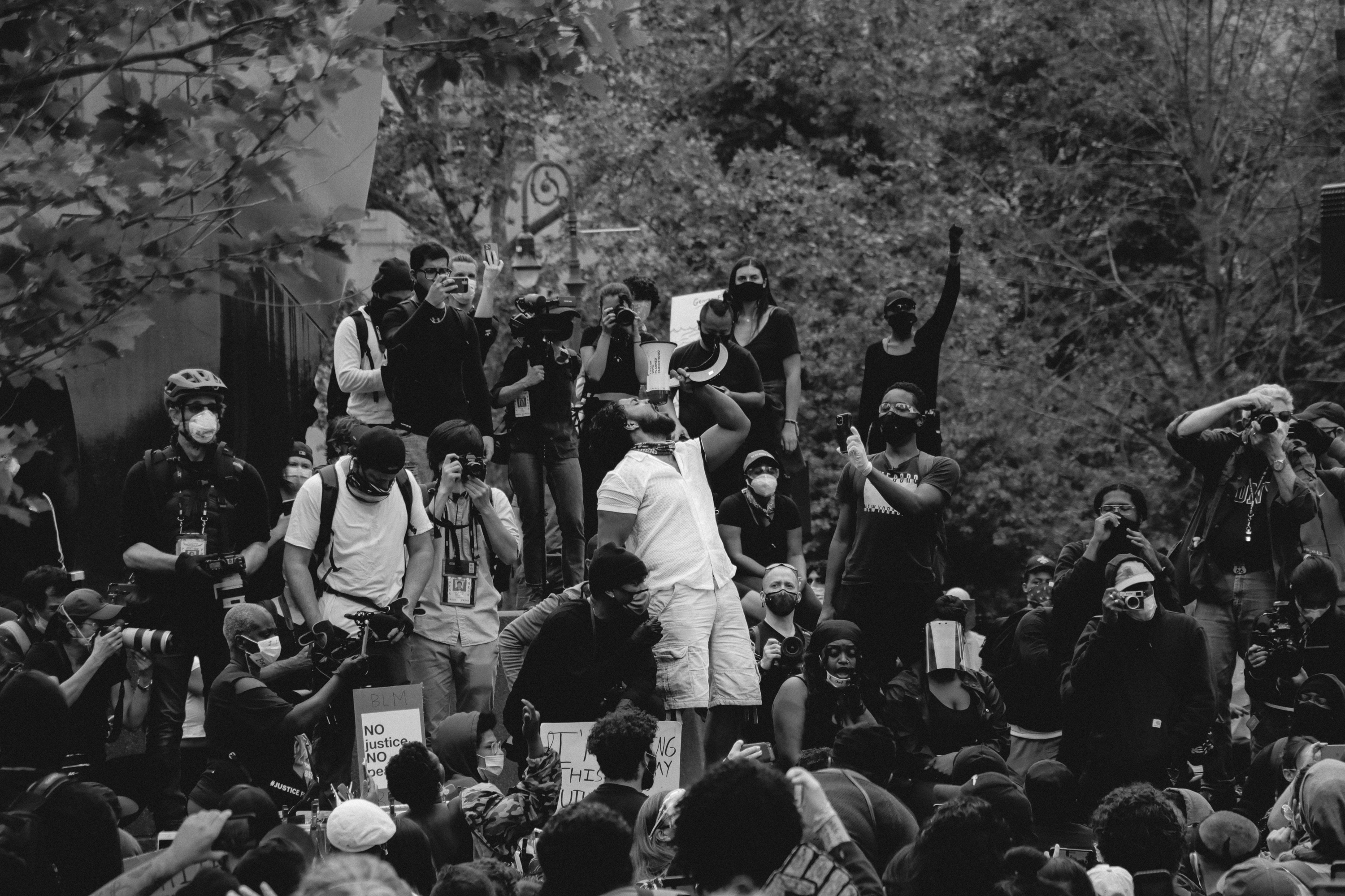 Grayscale Photo of People Protesting on the Street